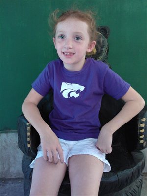 Natalie on the bear chair, she’s sorta smiling